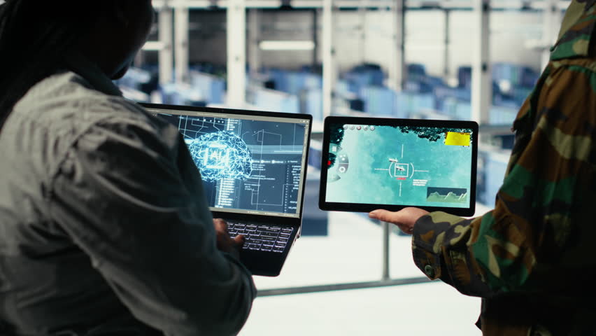 Close up of army general and coworker in data center integrating AI into radar systems for missile tracking. Teamworking soldier and technician in server hub analyzing aerial movement on device