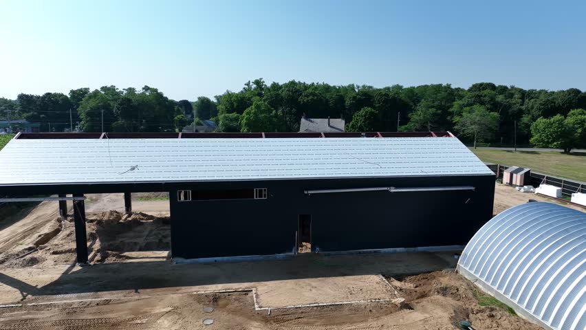 drone flying over a construction site with blue sky above