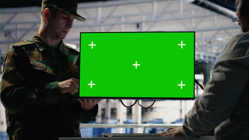 Soldier and female technician use green screen computer to manage server hub systems. African american woman and army commander use mockup workstation in data center, camera B - Powered by Shutterstock - Get 15% off with code: PIKWIZARD15