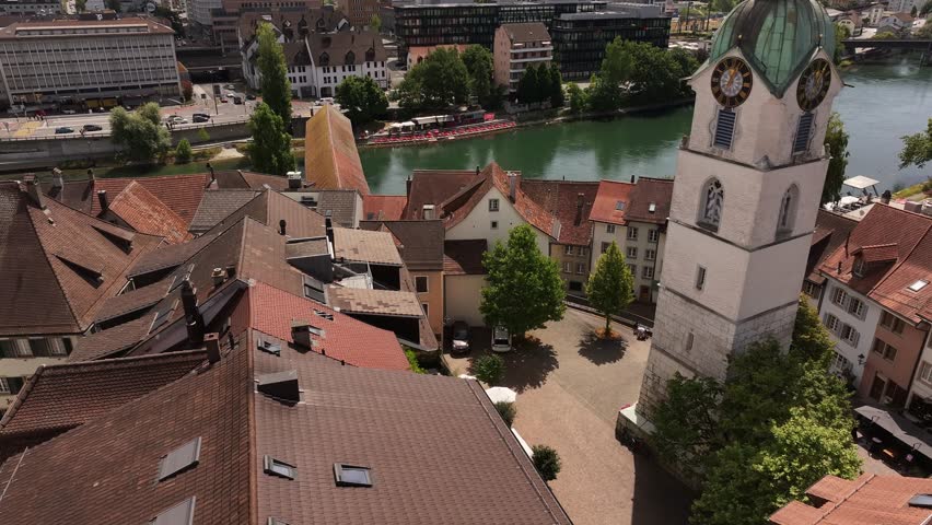 Aerial view of Olten clock tower and historic rooftops with river backdrop in Switzerland.