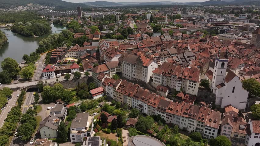 Aerial view of Aarau, the capital of the canton of Aargau, Switzerland. The historic old town with its signature red-tiled rooftops, narrow streets, and the Aare River flowing beside it.