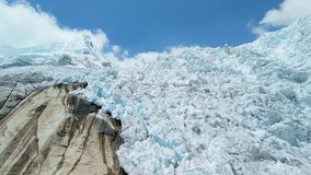 A striking aerial parallax shot reveals the frozen snow-capped peak and fractured glacier ice of Nevado Hualcán in the Cordillera Blanca near Laguna 513 - Powered by Shutterstock - Get 15% off with code: PIKWIZARD15