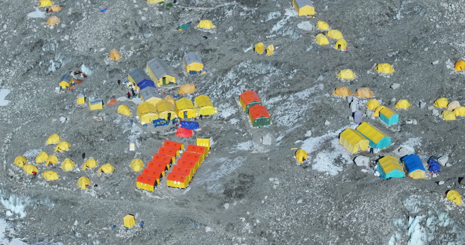 Drone shot of Everest Base Camp with climbers’ tents around summit start point causing tent pollution, and landscape of white Khumbu glaciers in dry terrain exploration in Nepal himalayas tourism