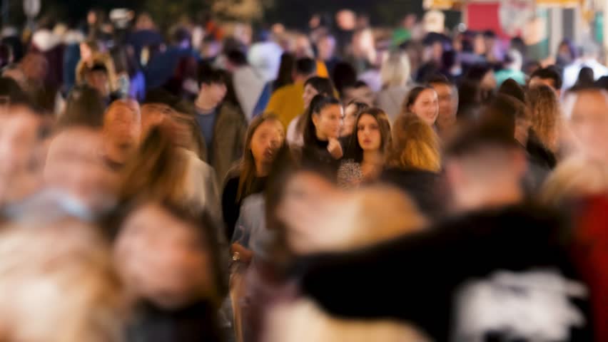 Timelapse Crowd of People Walking a Busy Street at Night. People in Motion Blur and Vibrant Town Atmosphere. Representing Urban Life and Activity Video Showing a Large Group Persons Along Outdoor 4k