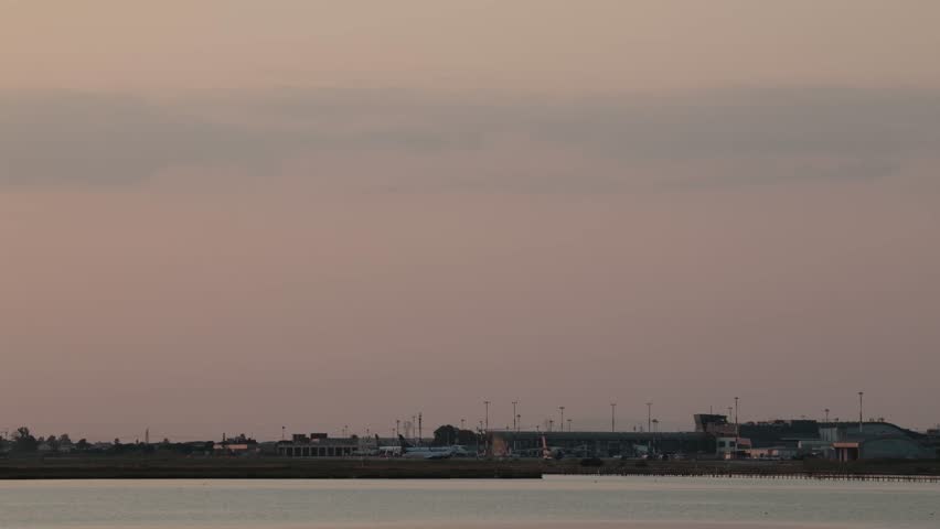 Cagliari, Sardinia, Italy A commercial airliner takes off at the Cagliari Elmas Airport at sunset.