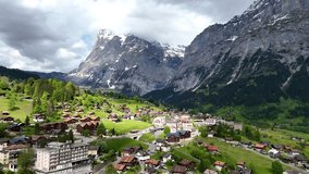 Drone flying along alpine ridges above Grindelwald, showcasing panoramic views of snow-capped peaks and verdant valleys. - Powered by Shutterstock - Get 15% off with code: PIKWIZARD15