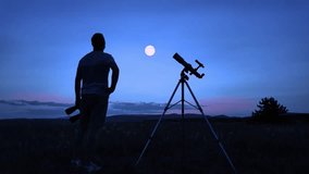 Amateur astronomer using telescope and binoculars for watching stars, Moon, planets and other celestial objects from a field in nature. - Powered by Shutterstock - Get 15% off with code: PIKWIZARD15