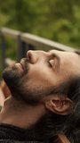 Engulfed in tranquility, a man breathes deeply as he meditates outdoors, surrounded by nature's lush greenery, embodying inner peace and relaxation - Powered by Shutterstock - Get 15% off with code: PIKWIZARD15