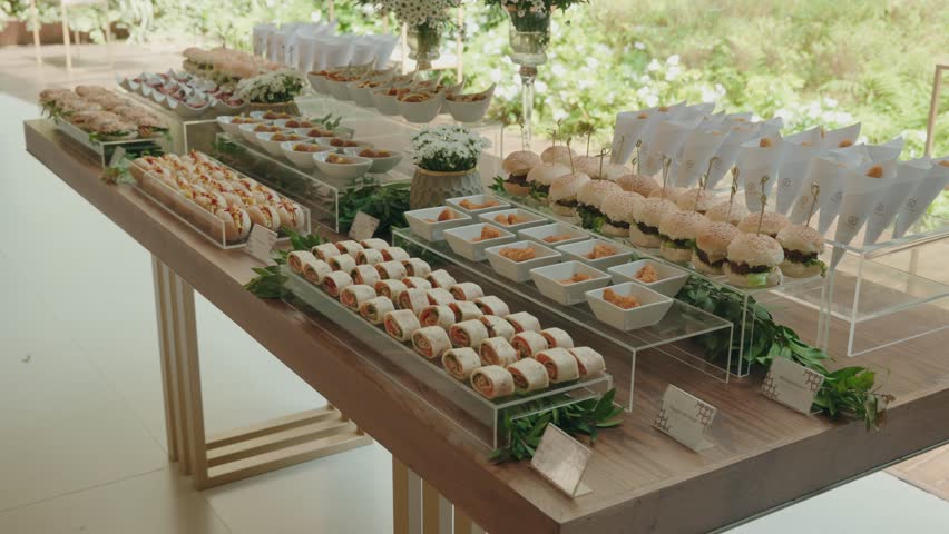 elegantly arranged wedding buffet table with mini burgers wraps and assorted gourmet appetizers