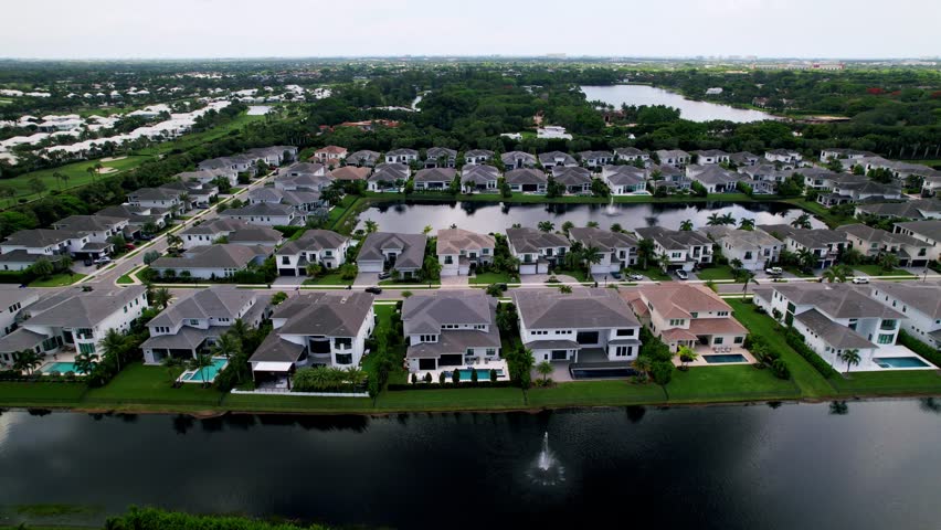 Aerial: residential area and lake during the day in West Palm Beach, Florida, USA, pan drone shot
