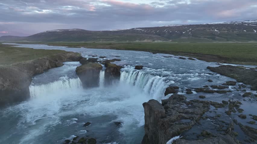 Aerial view of the powerful Goðafoss waterfall with its rushing waters and rocky landscape, creating a mesmerizing scene, pingeyjarsveit, Iceland.