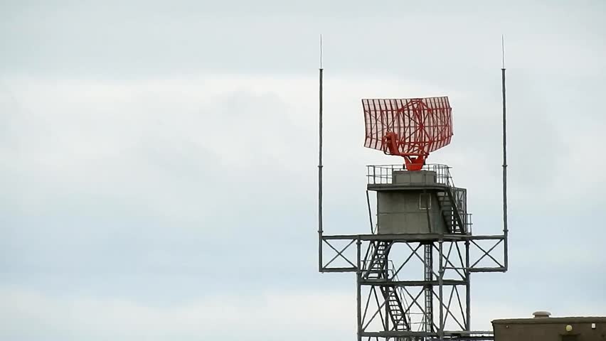 Air traffic control radar tower rotating across Welsh valley airport in Holyhead aerodrome