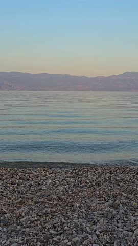 Baska Beach and Coastline With Clear Turquoise Water, Marina Boats, City Street, Sunny Summer Sunset  View on Krk Island, Croatia Adriatic Sea, Vela Plaza Beach, Mountains and Campsite Cityscape