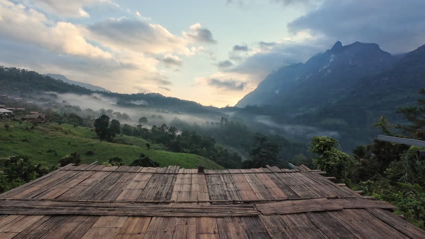 Scenic landscape of Doi Luang Chiang Dao limestone mountain with foggy on local tribe village in the dawn at Ban Na Lao Mai, Chiang Dao, Chiang Mai, Thailand