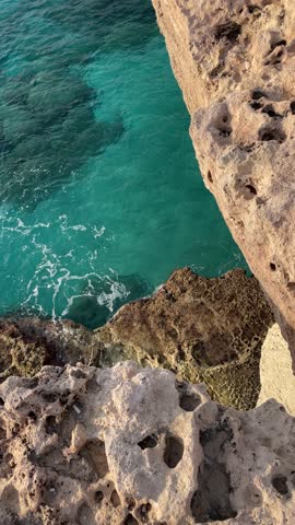 Breathtaking stock photo of Cyprus sea caves with crystal-clear turquoise waters, rugged cliffs, and natural rock formations. Ideal for travel, nature, and adventure marketing or blogging content.