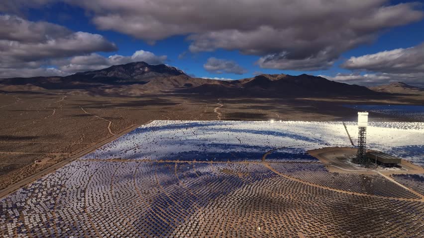 Aerial view of the Ivanpah Solar Electric Generating System, reflecting sunlight against the desert landscape, a blend of innovation and nature, California, United States.