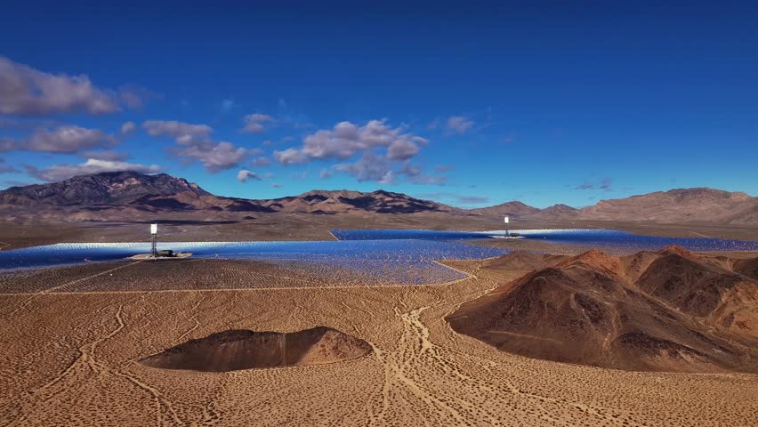 Aerial view of the Ivanpah Solar Electric Generating System with desert landscape contrasting against the bright blue sky, Nipton, San Bernardino County, United States.