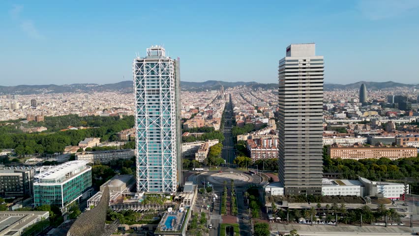 Aerial view of the iconic Hotel Arts and Torre Mapfre rising above the city, contrasting with the blue Mediterranean sea, Barcelona, Catalonia, Spain.