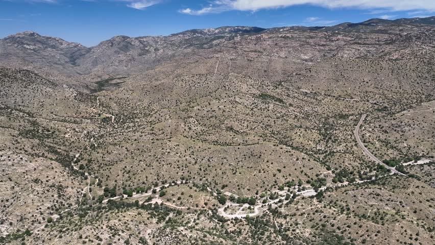 Aerial view of the rugged Santa Catalina Mountains, showing the arid landscape and winding roads in Coronado National Forest, Summerhaven, Arizona, United States.