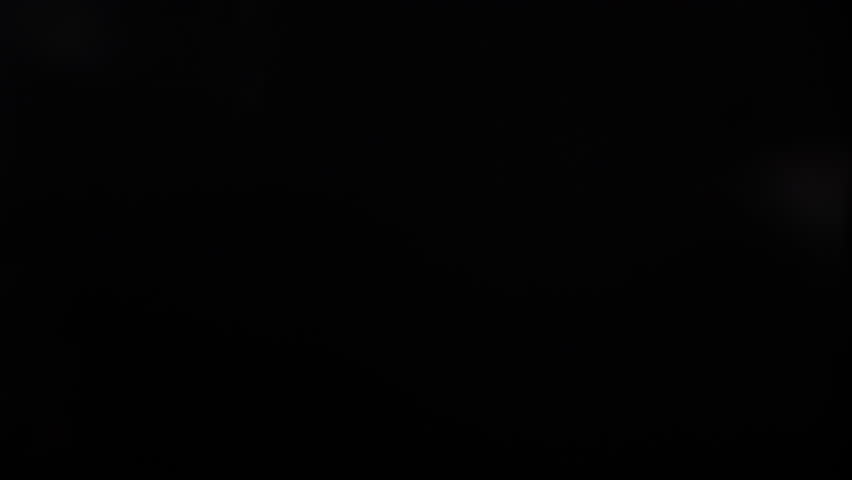 Thick vape smoke cloud slowly dispersing against a dark background.