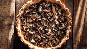 Close-up of freshly baked mushroom quiche with golden crust on rustic wooden table, delicious savory pie filled with sautéed mushrooms, perfect for gourmet cuisine and home cooking concepts. - Powered by Shutterstock - Get 15% off with code: PIKWIZARD15