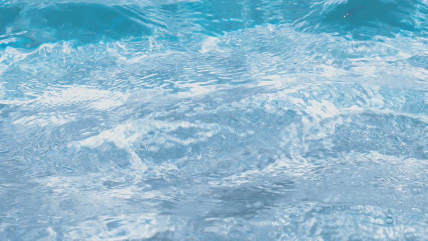 Mesmerizing clear blue pool water sparkling under radiant sunlight, gently swaying with a soft breeze—creating tranquil, shimmering visuals perfect for summer scenes, wellness content, or refreshing.