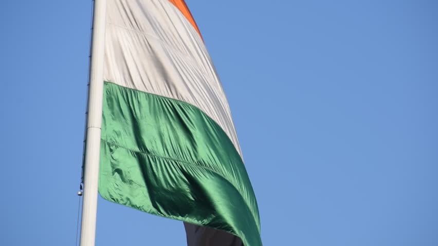 India flag flying high at Connaught Place with pride with plain white background, India flag fluttering, Indian Flag on Independence Day and Republic Day of India, tilt up shot, Har Ghar Tiranga