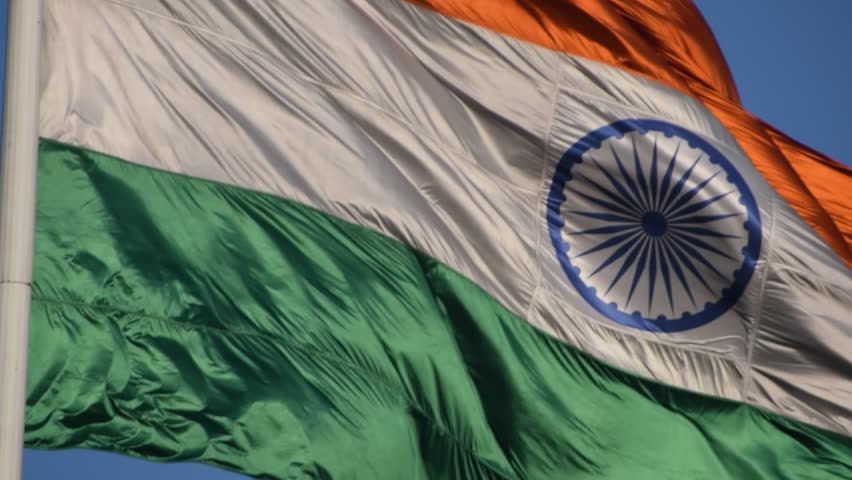 India flag flying high at Connaught Place with pride with plain white background, India flag fluttering, Indian Flag on Independence Day and Republic Day of India, tilt up shot, Har Ghar Tiranga
