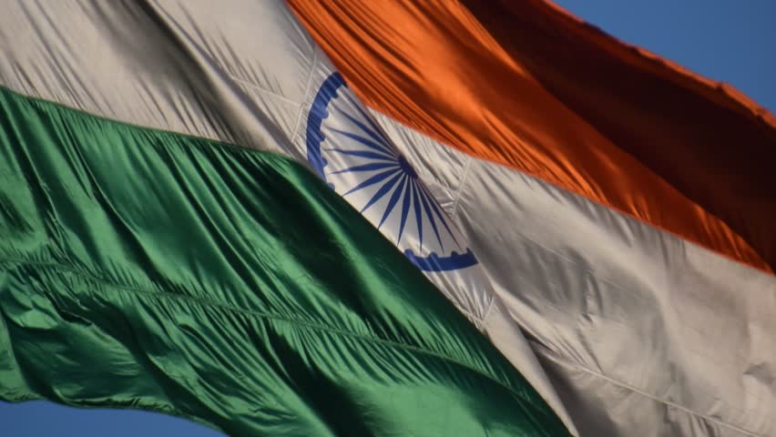 India flag flying high at Connaught Place with pride with plain white background, India flag fluttering, Indian Flag on Independence Day and Republic Day of India, tilt up shot, Har Ghar Tiranga