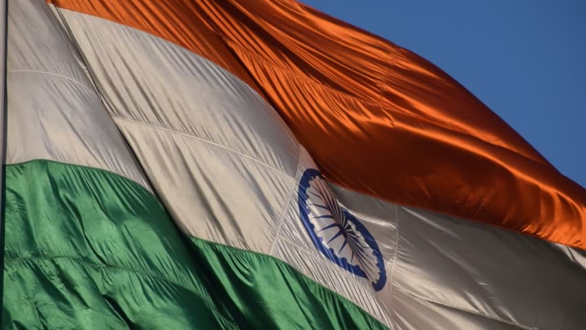 India flag flying high at Connaught Place with pride with plain white background, India flag fluttering, Indian Flag on Independence Day and Republic Day of India, tilt up shot, Har Ghar Tiranga