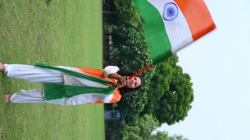 A indian girl holding flag of India in their hands and celebrating independence day of india. Gurgaon, India. August 11, 2025.