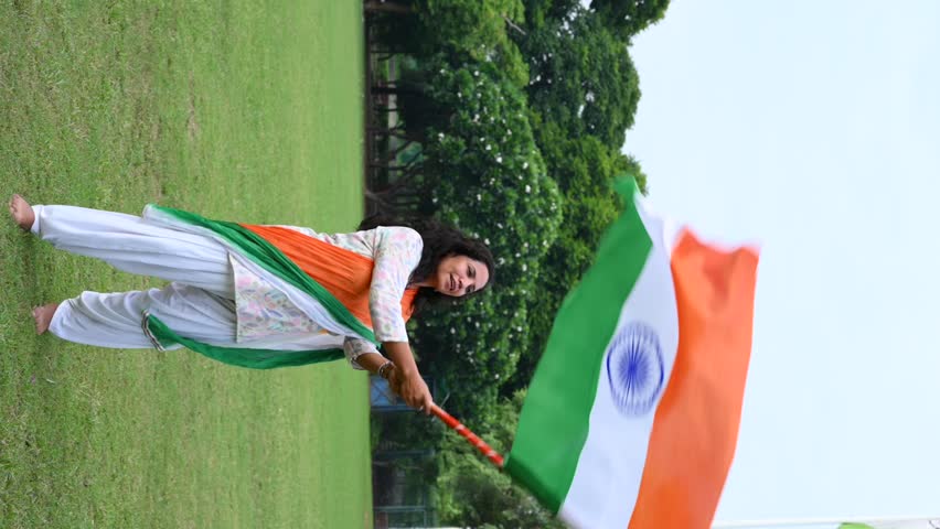A indian girl holding flag of India in their hands and celebrating independence day of india. Gurgaon, India. August 11, 2025.