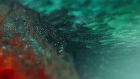 Macro view of green and orange glittery inks forming bubbles and wave-like patterns, resembling a snake skin texture. - Powered by Shutterstock - Get 15% off with code: PIKWIZARD15