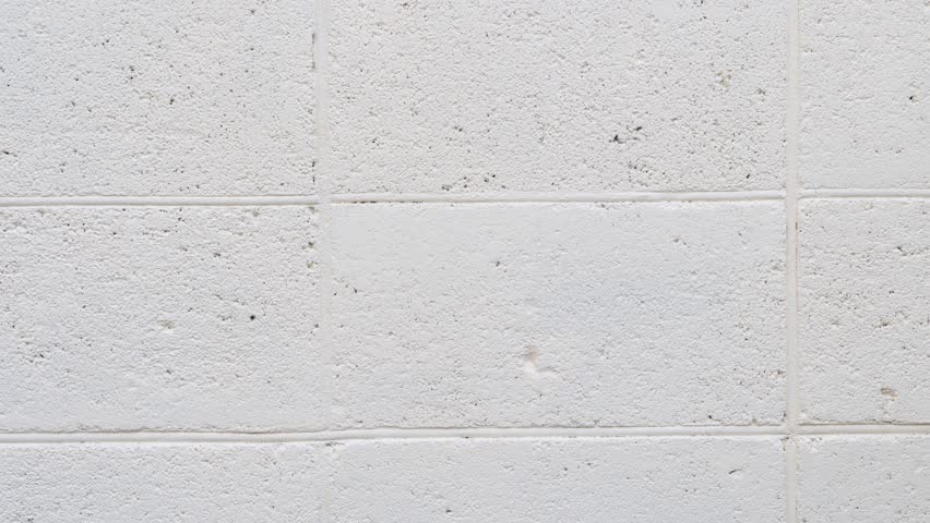 Green spray drawing a cross mark on wall animation