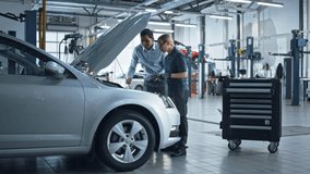 Auto Repair Shop: Manager Checks Tests on a Tablet Computer and Explains an Engine Breakdown to an Female Mechanic. Car Service Employees Inspect Car's Engine BayModern Clean Workshop. - Powered by Shutterstock - Get 15% off with code: PIKWIZARD15