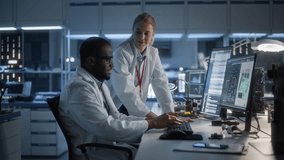 In Ultra Modern Lab, Engineers Engage in Microchip Innovation, Utilizing Advanced Software on Screens. the Environment Fosters Cutting-edge Semiconductor Design and Collaborative Problem-solving. - Powered by Shutterstock - Get 15% off with code: PIKWIZARD15