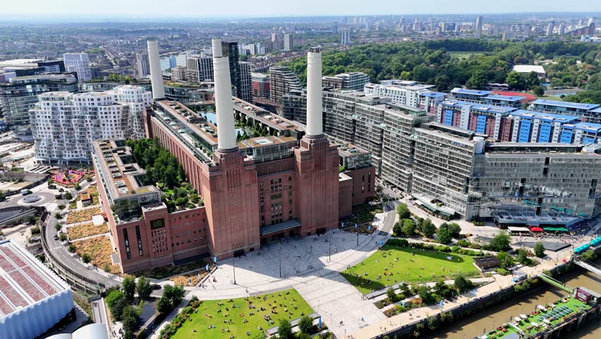 Scenic aerial shot over Battersea in London, revealing the redeveloped Power Station, luxury flats, and vibrant riverside scene along the Thames.