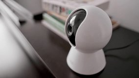 Security camera with sleek white housing and black lens dome, indoor wireless surveillance, home monitoring, property protection, smart home automation, and advanced safety systems, privacy security - Powered by Shutterstock - Get 15% off with code: PIKWIZARD15