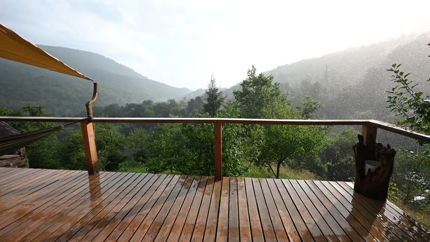 Peaceful Rain Falling on a Wooden Deck with a Stunning Mountain and Forest View.