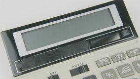 VAT text or words with a hand typing on a calculator, symbolizing tax calculation, value-added tax processing, financial compliance, and billing management on a white background - Powered by Shutterstock - Get 15% off with code: PIKWIZARD15