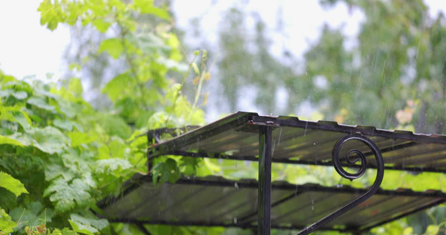 Falling raindrops on surface of metallic roof or profiled flooring. Slow motion. Meteorological Phenomena. Seasonal Time of Year. The Vagaries of Nature.