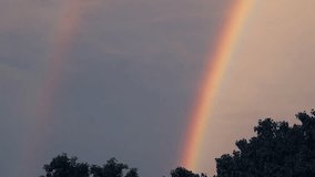Footage of Magical Twin Rainbows bending in the Twilight Sky - Powered by Shutterstock - Get 15% off with code: PIKWIZARD15