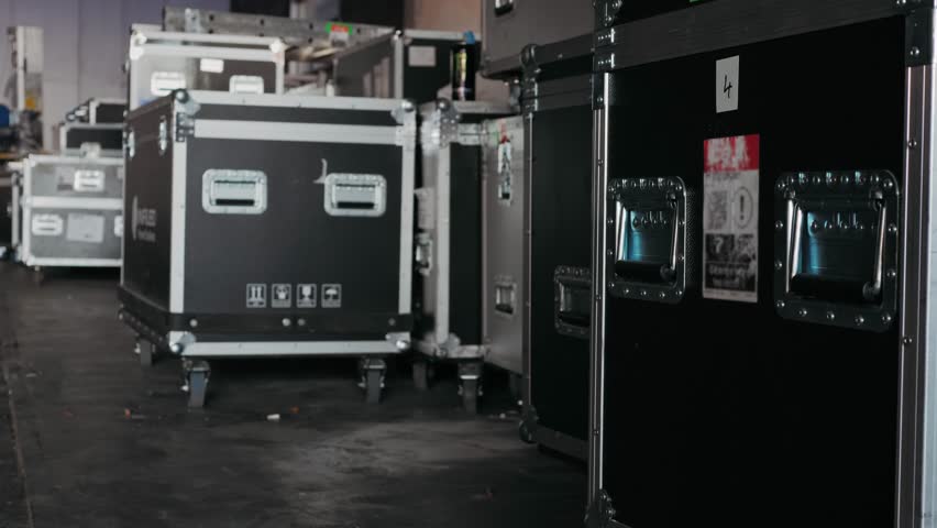 Music acoustics transportation boxes, Sound engineering Installation professional audio equipment live concert,backstage zone. Racks with stereo speakers amplifiers, subwoofer power distribution boxes