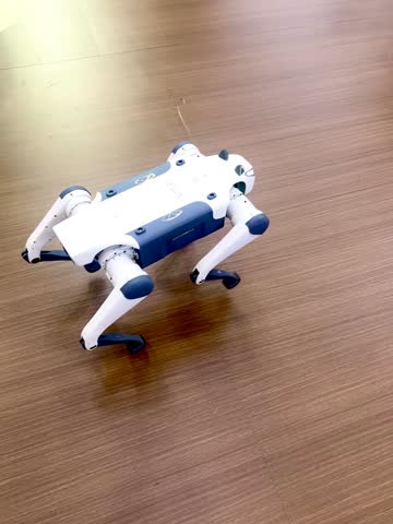A robot dog walking and playing around people at a technology trade show. Concept of robotics engineering innovation. 
