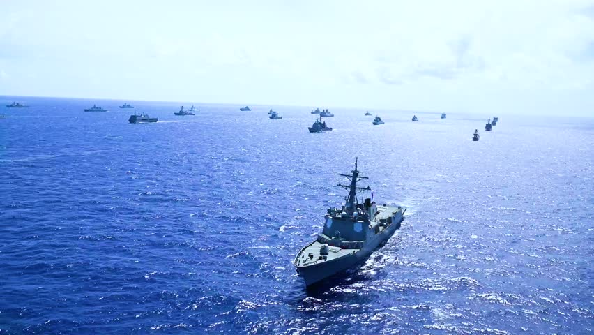 In the middle of the sea, hundreds of destroyer warships are seen sailing together.