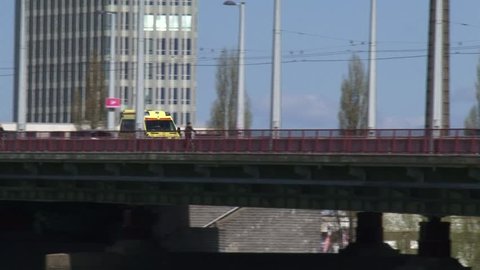Ambulance crossing Road Bridge - tracking shot. John Frost Bridge, Arnhem, The Netherlands.