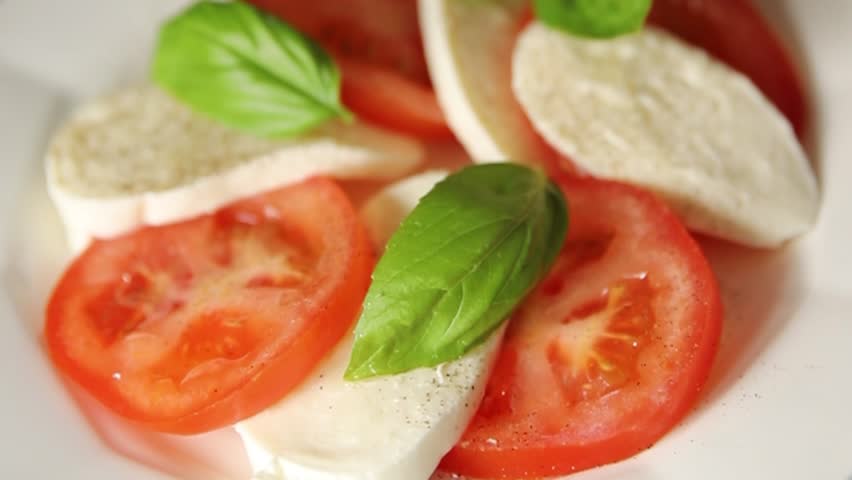 Caprese salad mozzarella and tomato, basil fresh delicious gourmet food background on the table rustic food top view copy space keto and paleo diet vegan and vegan food
