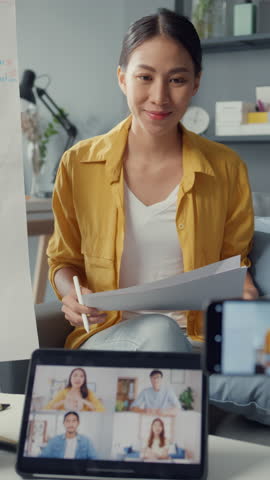Vertical Screen : Young Asia lady english teacher video conference calling on smartphone talk by webcam learn teach in online chat at home. Remote classroom, Social distancing, quarantine coronavirus.
