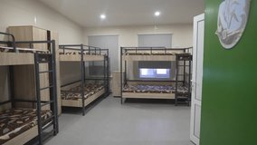 Dormitory features orthopedic mattresses atop sturdy bunk beds. Space offers comfort for young campers. Supportive mattresses enhance rest - Powered by Shutterstock - Get 15% off with code: PIKWIZARD15