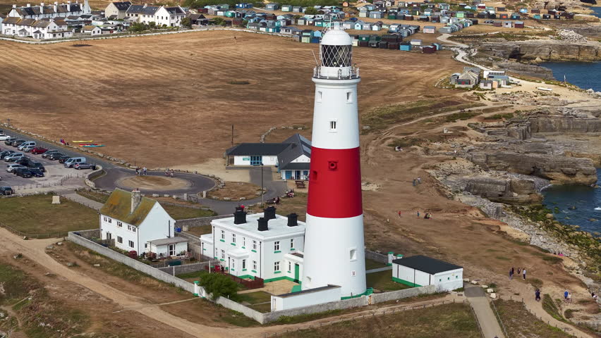 High angle drone orbit of the iconic Portland Bill Lighthouse on the Jurassic Coast